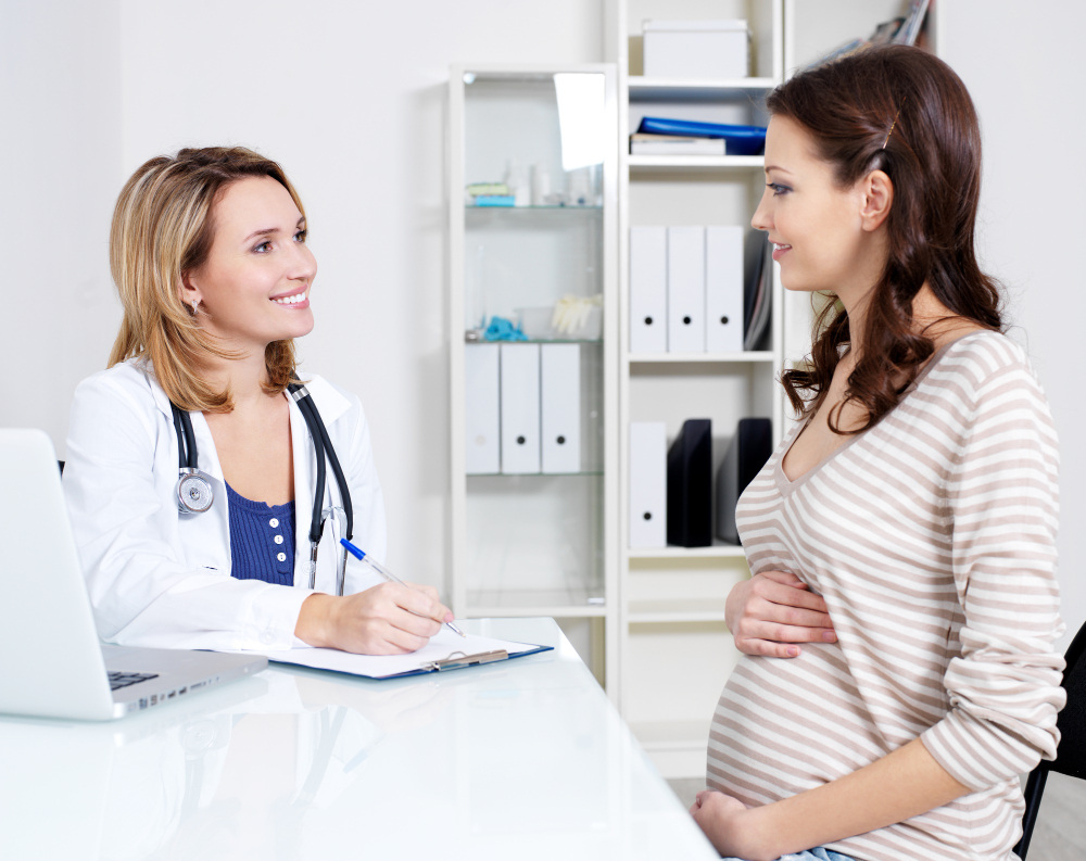 pregnant women with doctor on consultation.